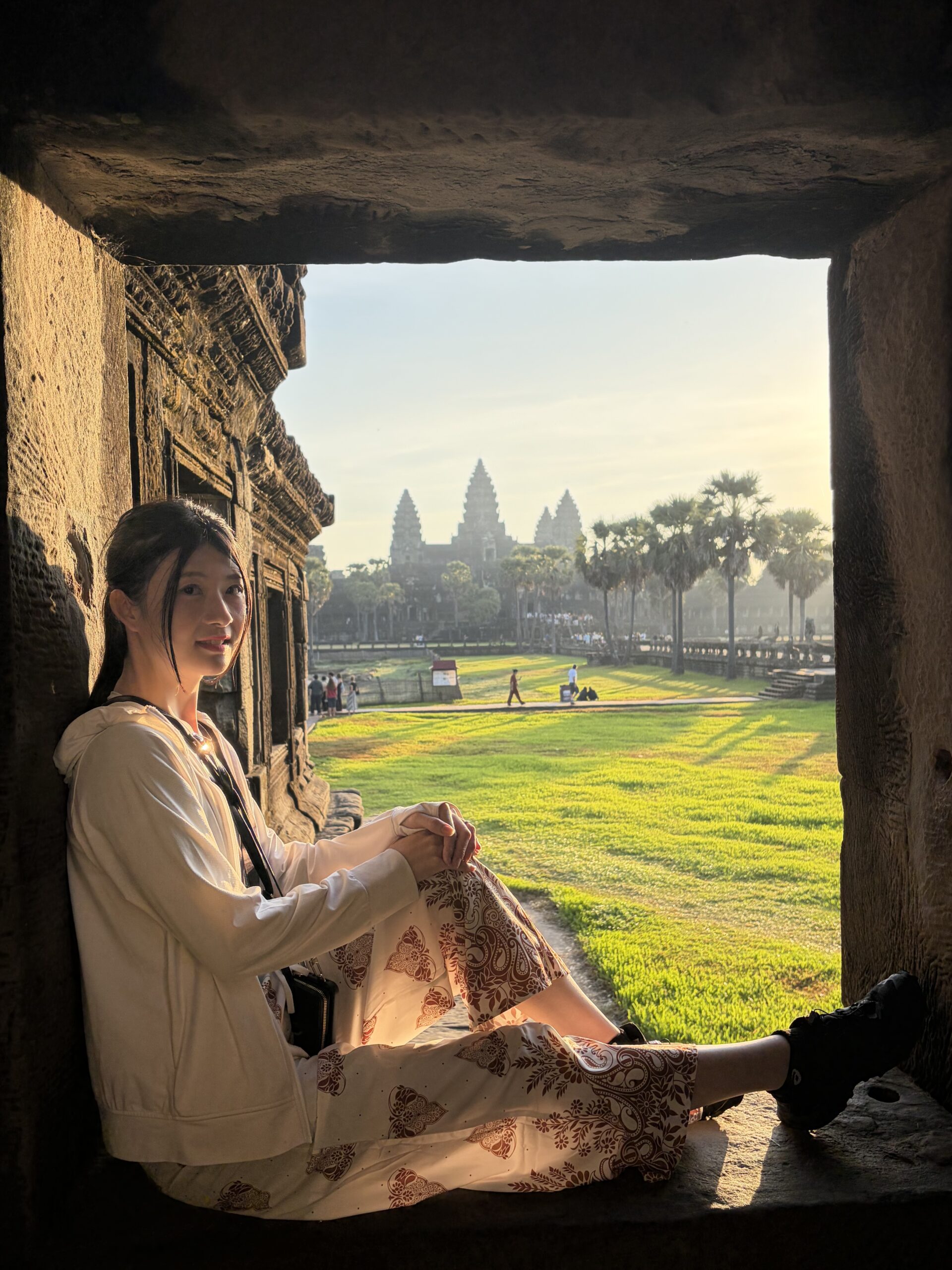 A traveler sitting quietly, gazing at the temple ruins