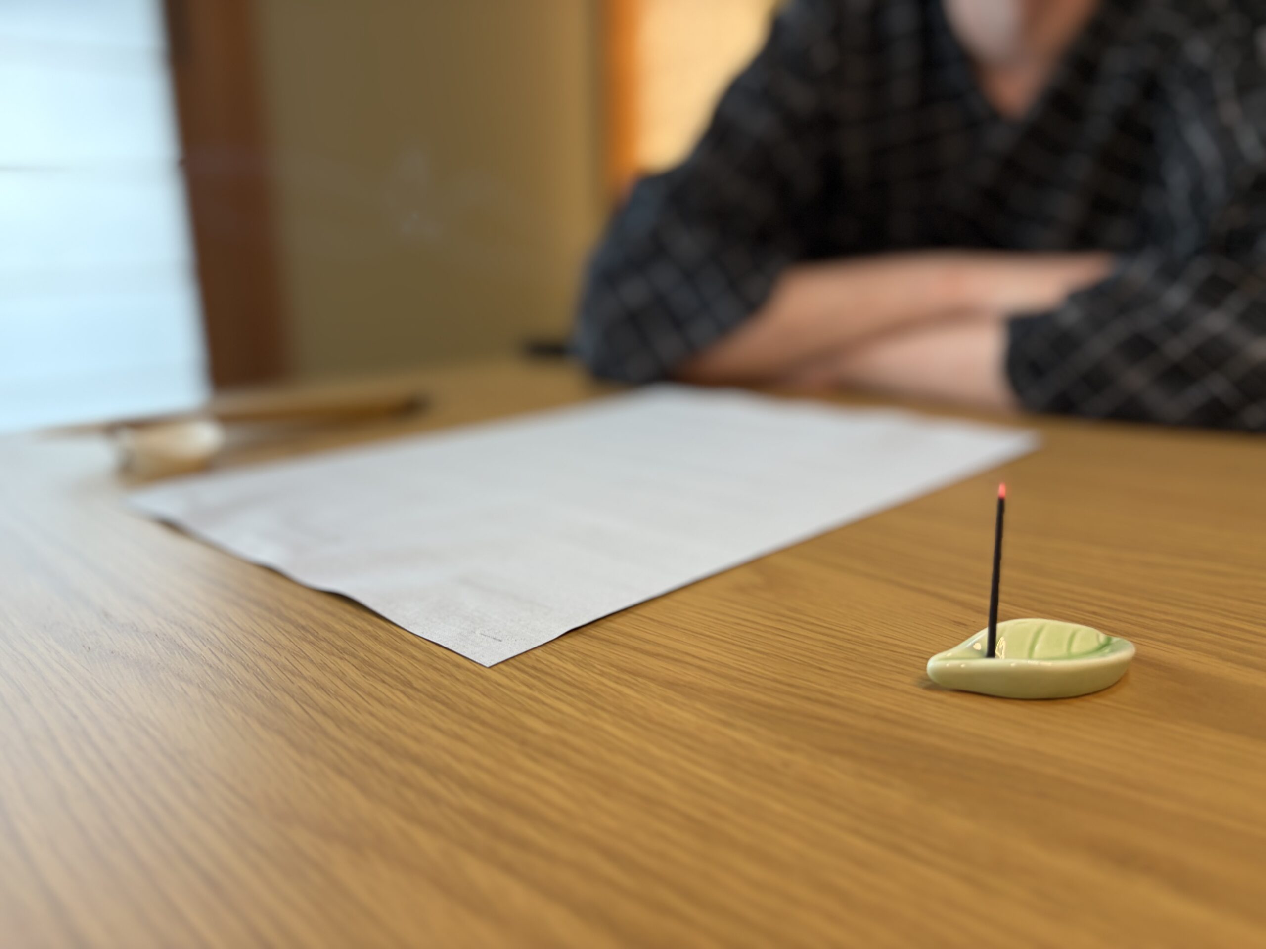 Calligraphy tools laid out on a wooden desk
