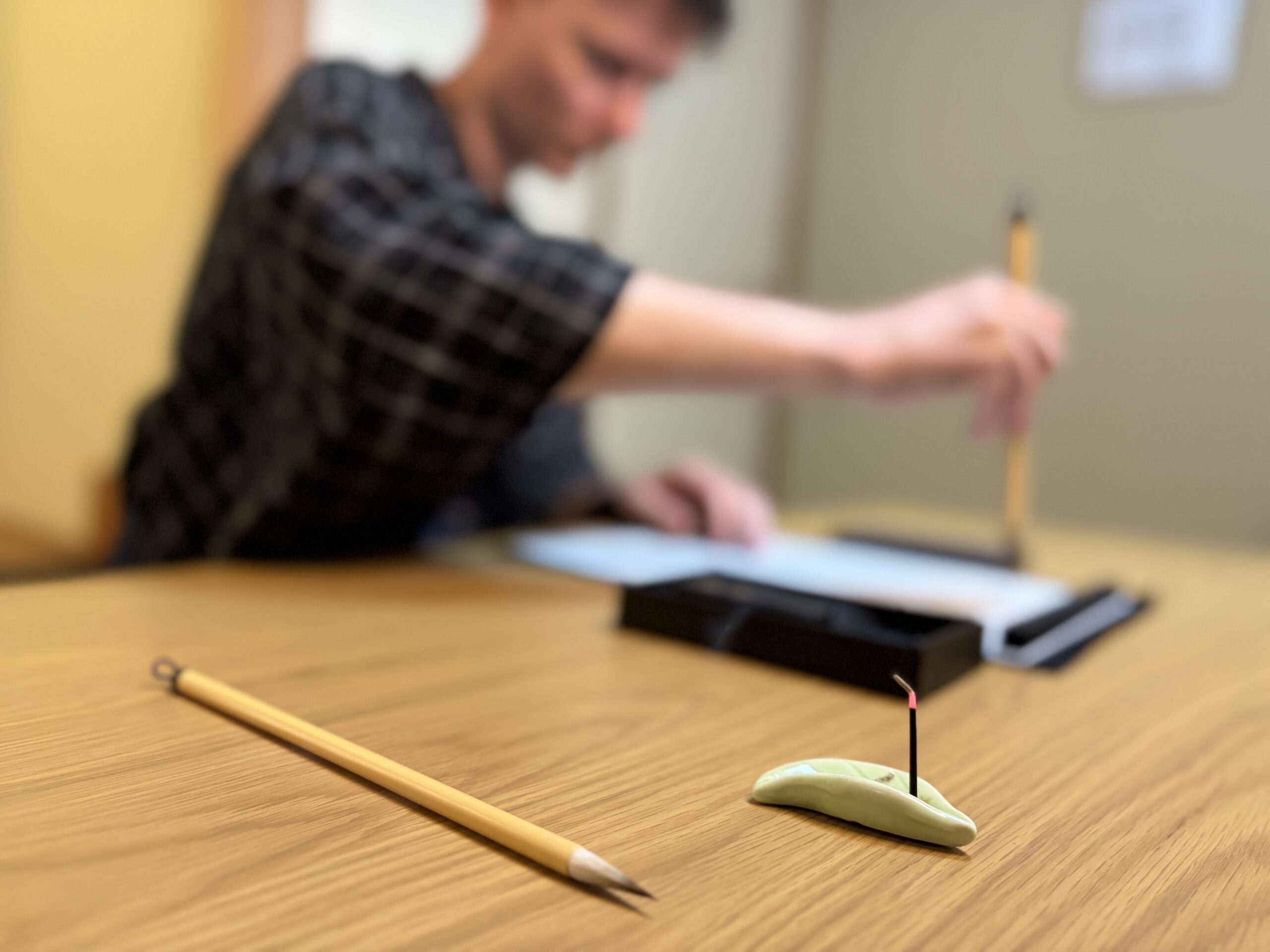 Writing with incense burning in the background